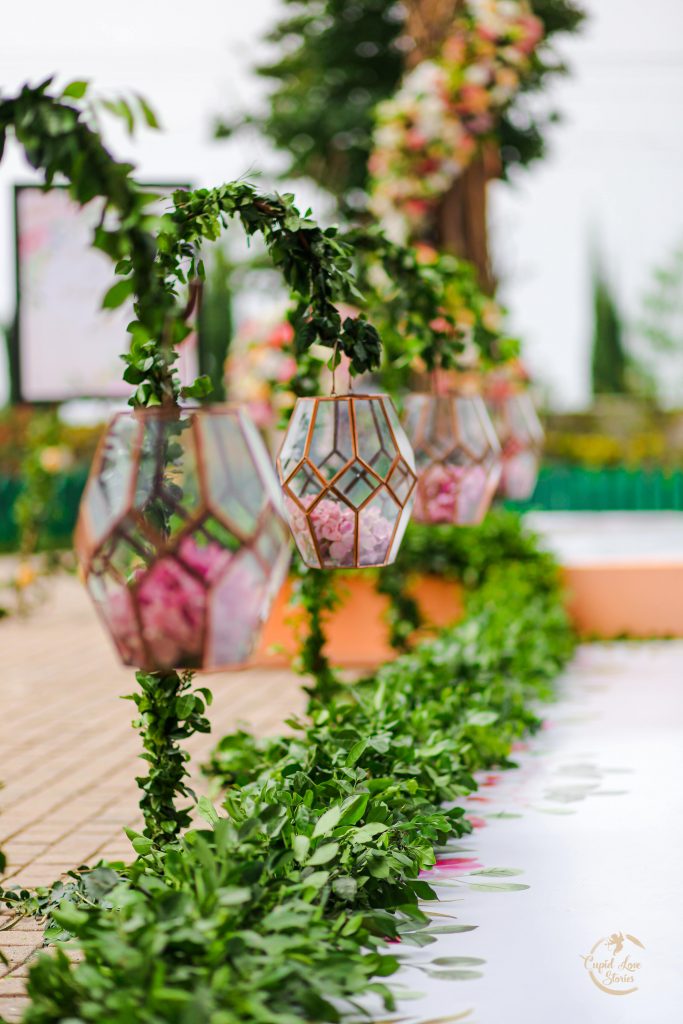 Picture of Rose Petals Filled Glass Terrariums Used in the Enchanted Garden Themed Decor at Aparna & Arnav's Destination Engagement Party