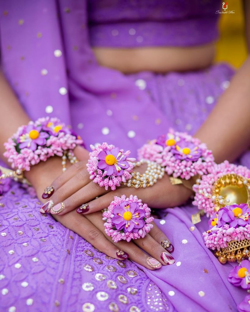 3d purple haldi ceremony nail art with purple flower jewellery 