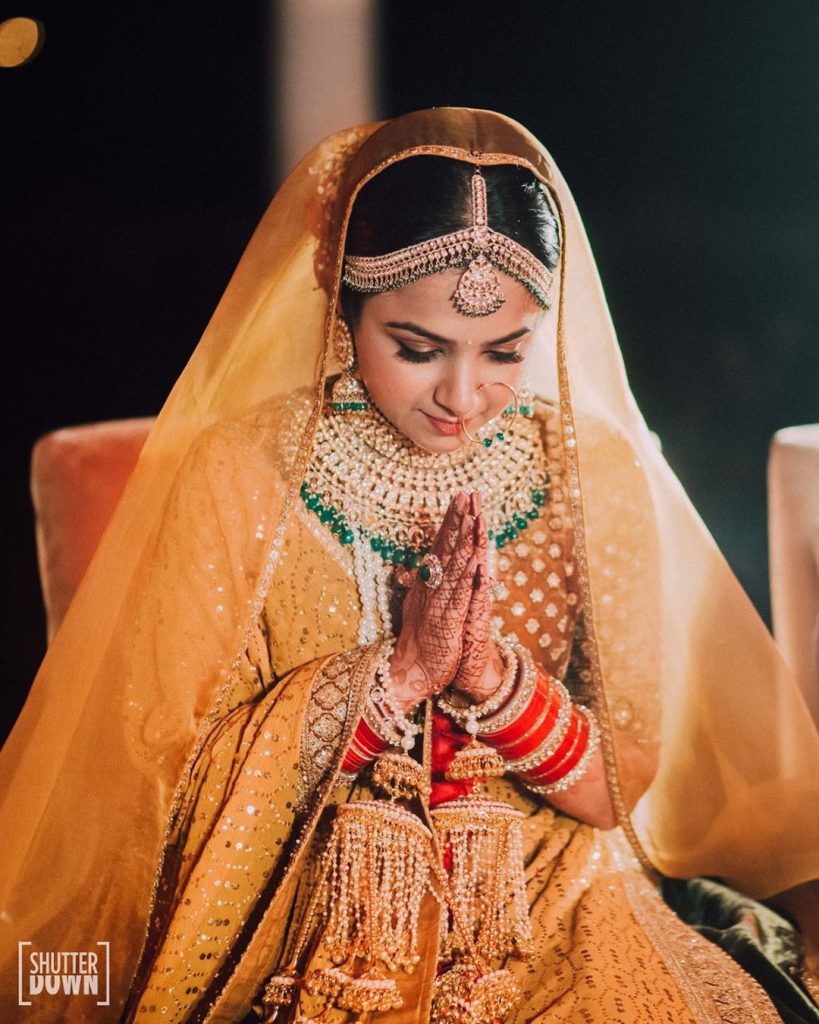 Mrighna's Solo Portrait in Gold Velvet Sabyasachi Lehenga from wedding rituals at her beach wedding in Dubai