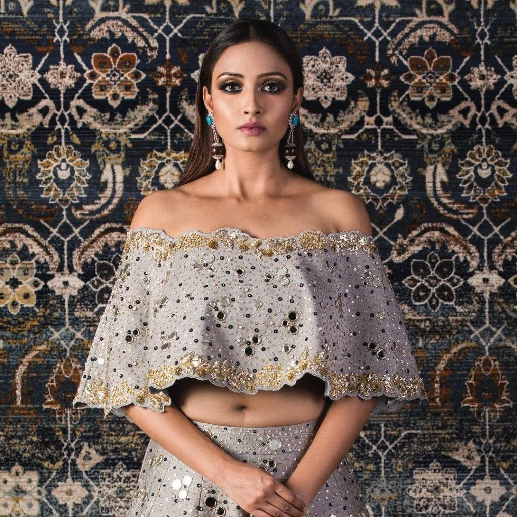 Cape blouse with lehenga with scalloped edges and mirror details 