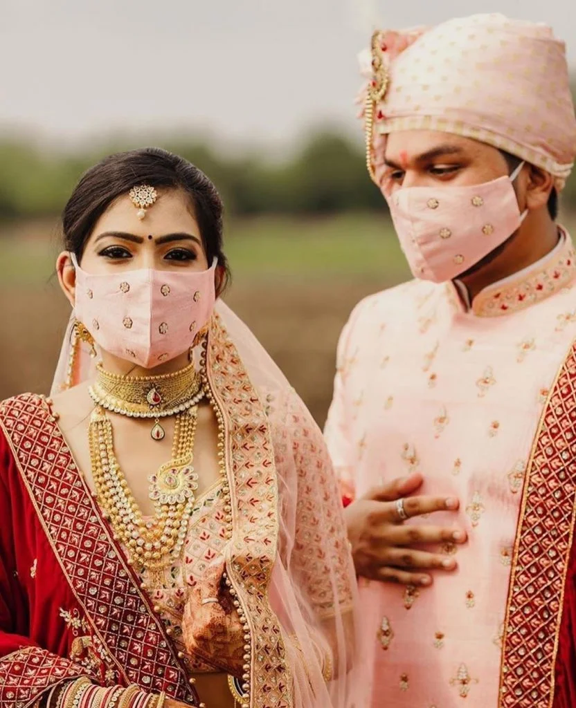 couple pastel pink wedding face masks photograph