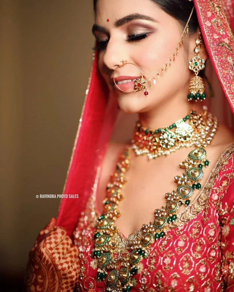 Metallic gold and brick red cut crease bridal eye makeup by Ravindra Photo Sales