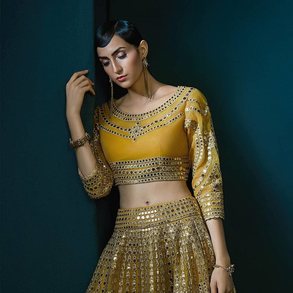 Mirror work lehenga design with U-neck and sleeves. 