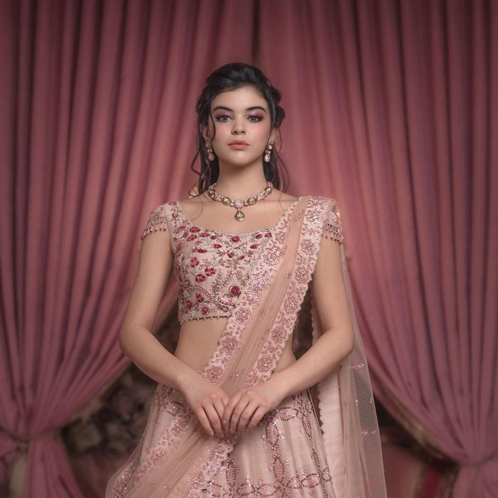 Pastel pink bridal lehenga with tassel details 