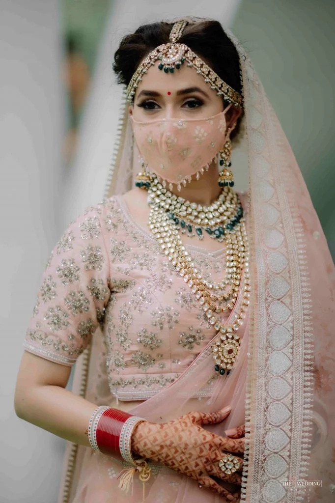 offbeat pastel indian wedding face mask with hanging small stones