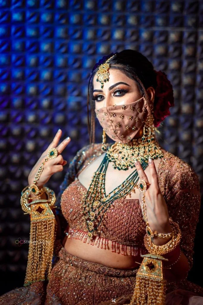 pastel pink bridal mask with sequin flowers and crop sequin pastel blouse for Indian bride