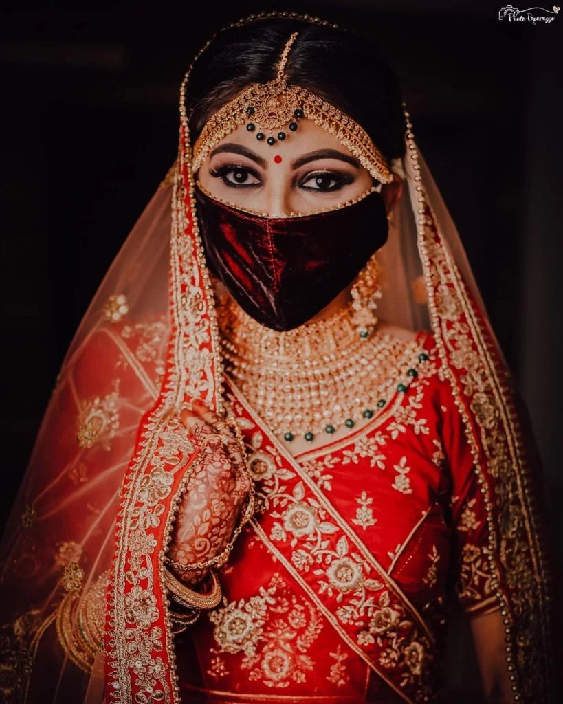 velvet red bridal face mask with kohl eye makeup and bold brows