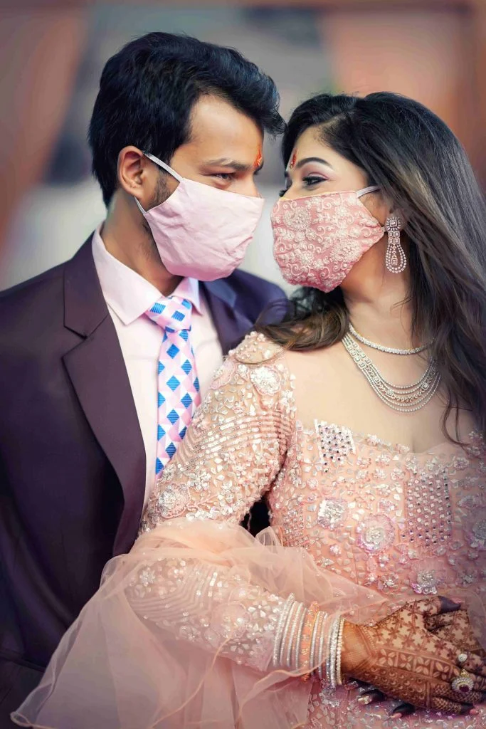 couple posing with plain and embroidered face masks 