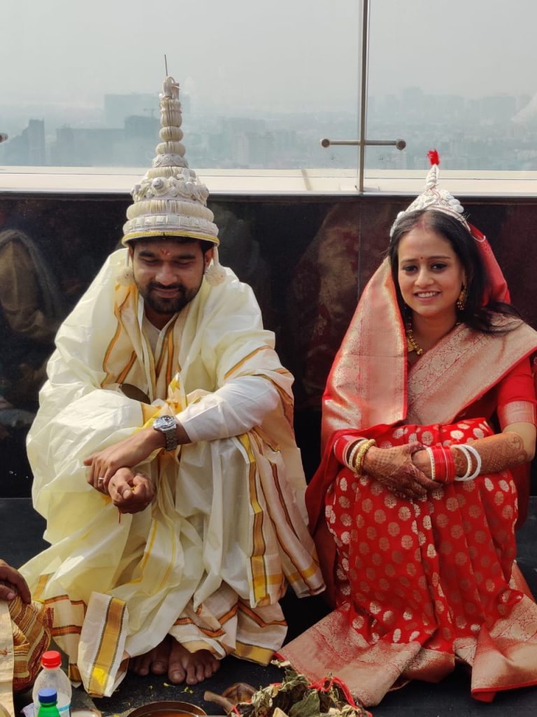 traditional bengali ceremony of bashi biye with bride in red indian saree