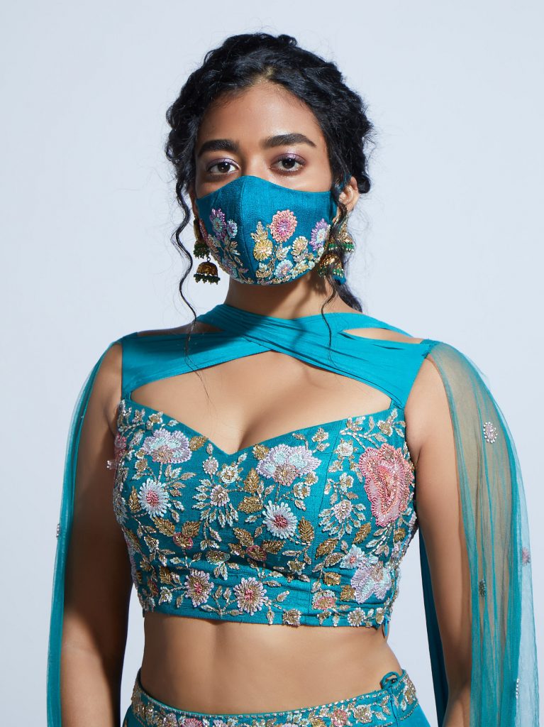 turquoise blue face mask with pastel embroidered flowers and crop floral blouse 