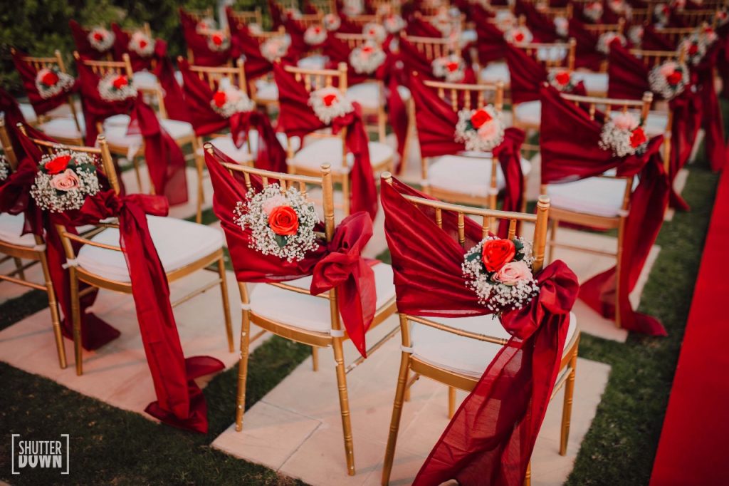 Red Theme Floral Guest Chair Decor at Mrighna & Shallabh's Red & Gold Themed Beach wedding in Dubai