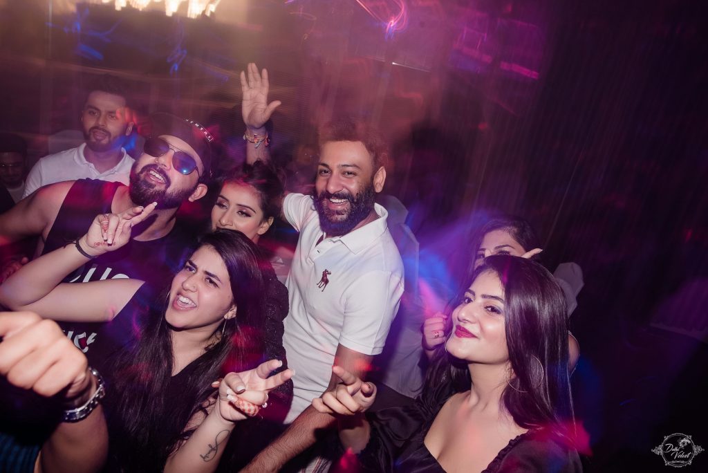 people dancing in electrifying beach wedding after party