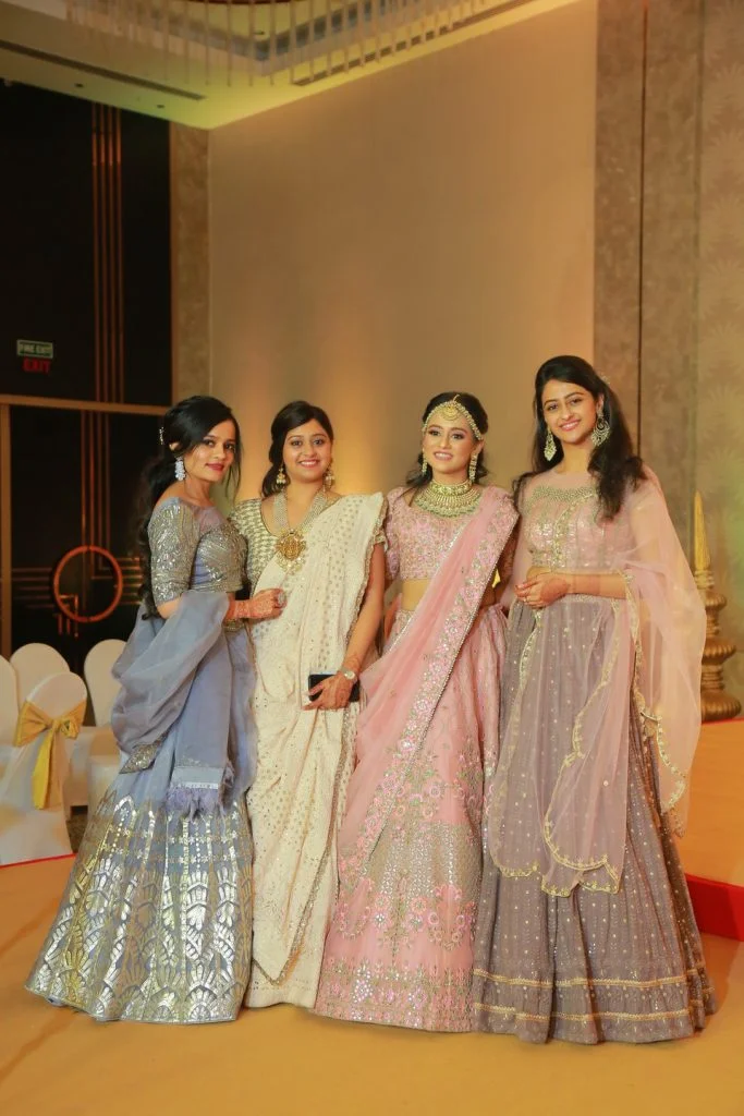 bride and bridesmaids in offbeat lehengas for wedding reception