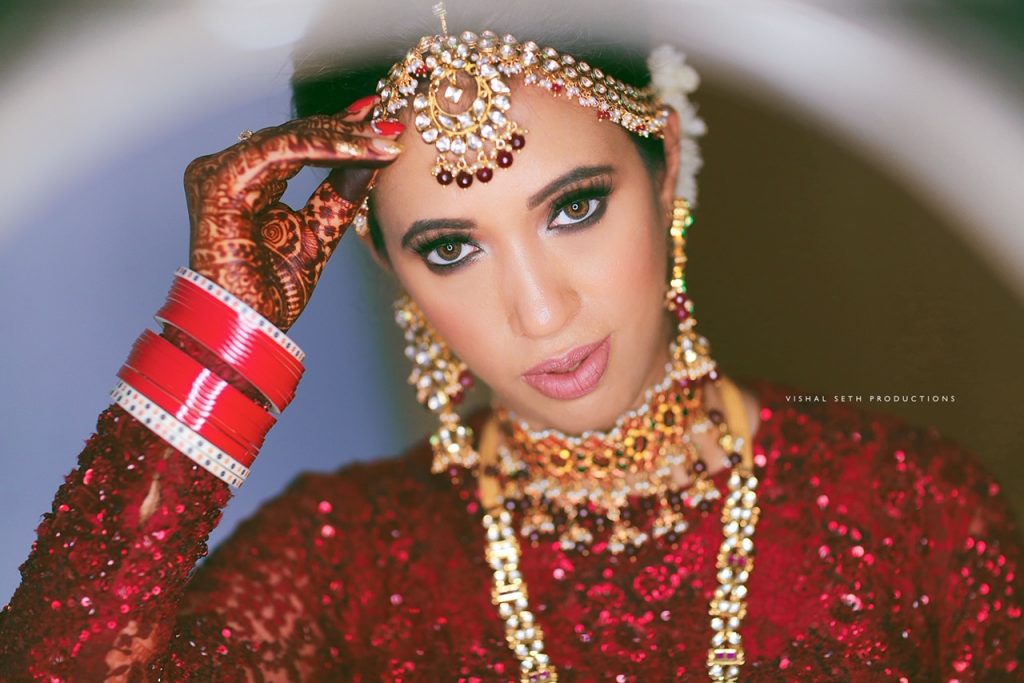 Image of Indian Bride dressed up in red saree portrait in Studio Lighting /  Traditionally dressed up girl-WT582042-Picxy