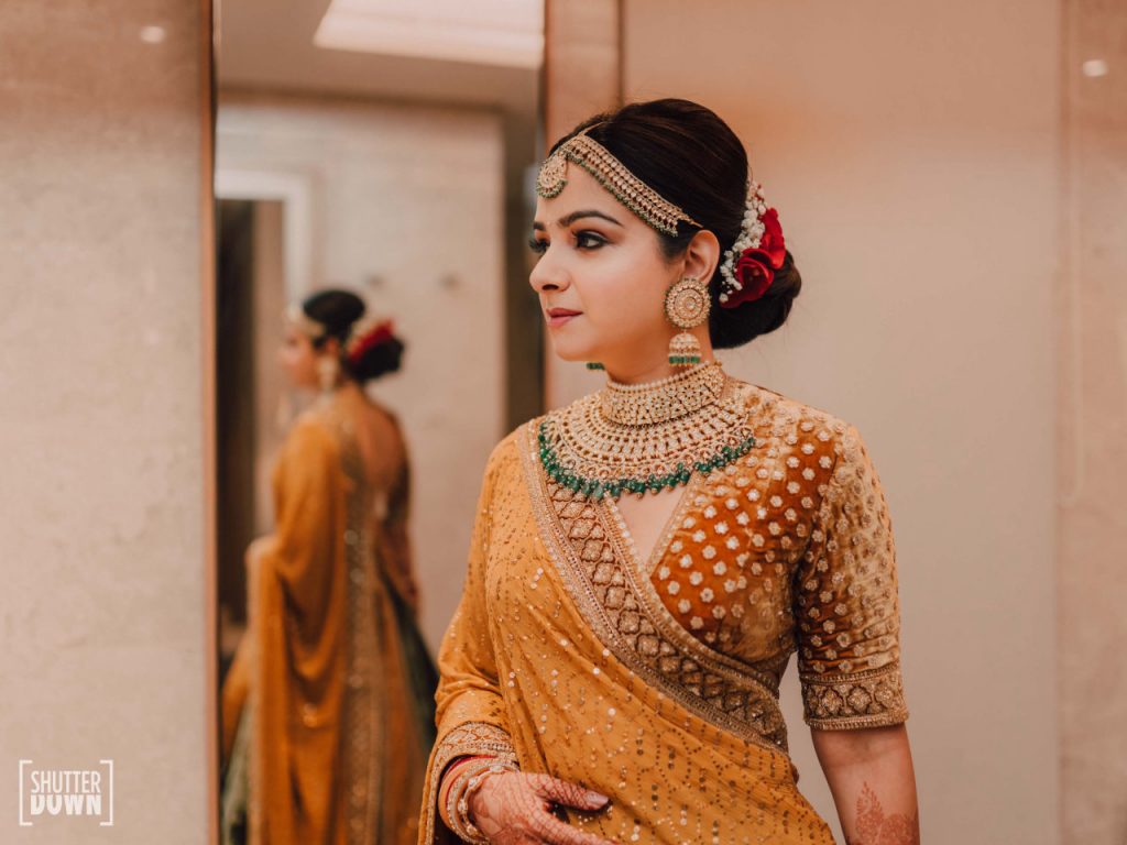 bridal photoshoot in golden sabyasachi lehenga with bridal jewellery by Maya Sanghvi