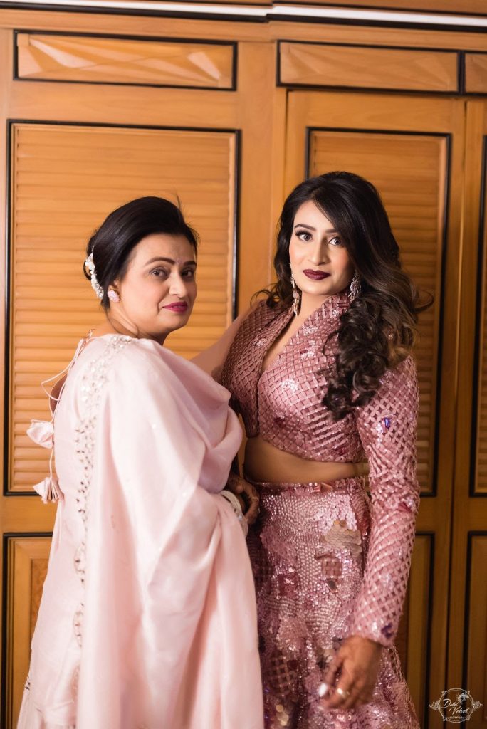 bride in pink shimmery sangeet lehenga with mother fir beach sangeet in pattaya