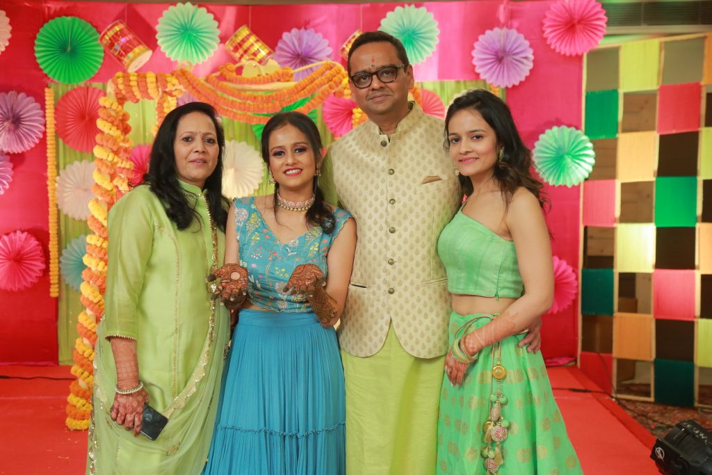 bride and family in ethnic clothing for mehendi ceremony