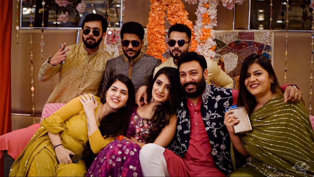 bridesmaids and groomsmen with couple in mehendi ceremony