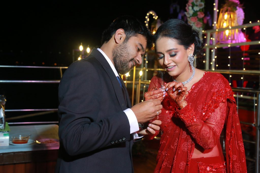 couple with engagement ring and bride in diamond choker and earring