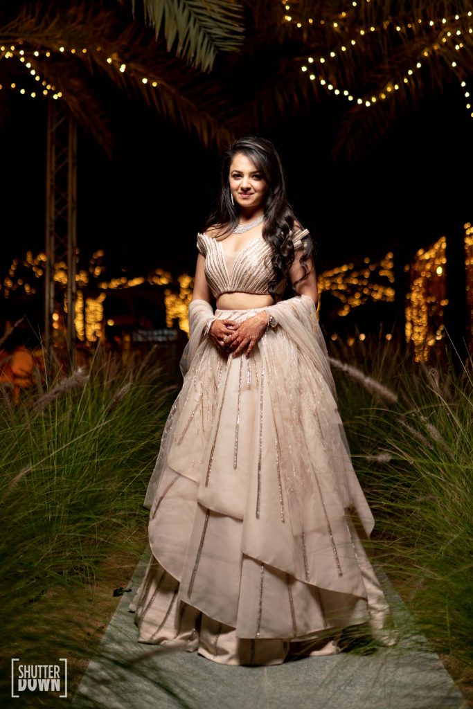 Mrighna's champagne pink shimmery off shoulder cocktail dress by Gaurav Gupta for the cocktail ceremony of her beach wedding in Dubai