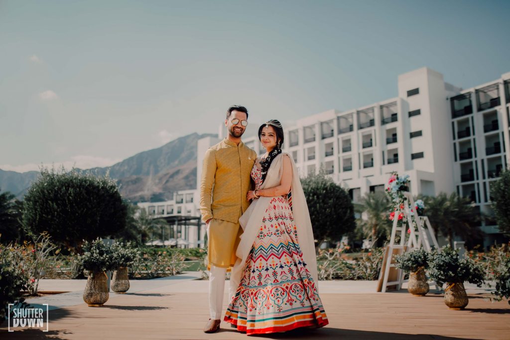 mehendi groom yellow kurta by Rajat Suri and white bridal lehenga by Tarun Tahiliani