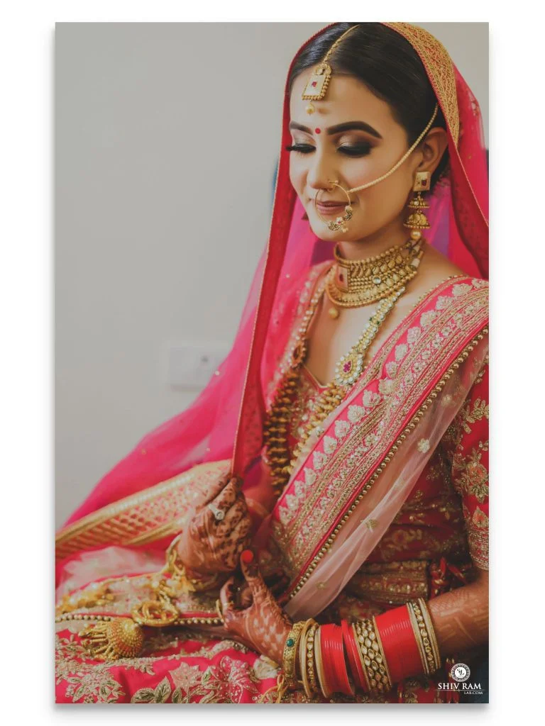 Indian bride in traditional pink lehenga and cut crease golden black eye makeup for 2020