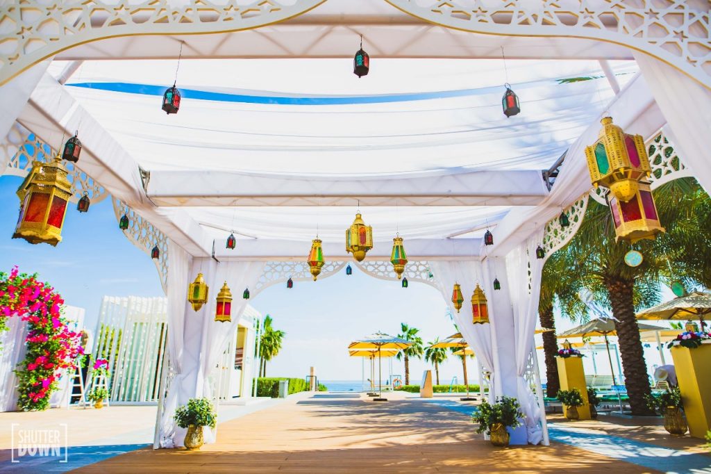 glass lamps and white outdoor tent for poolside moroccan mehendi decoration by Ferns and Petals Weddings