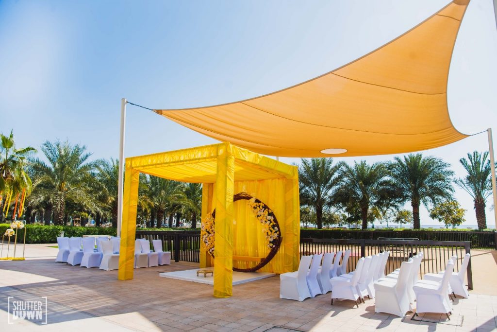 beach wedding in dubai haldi floral yellow ceremony stage 