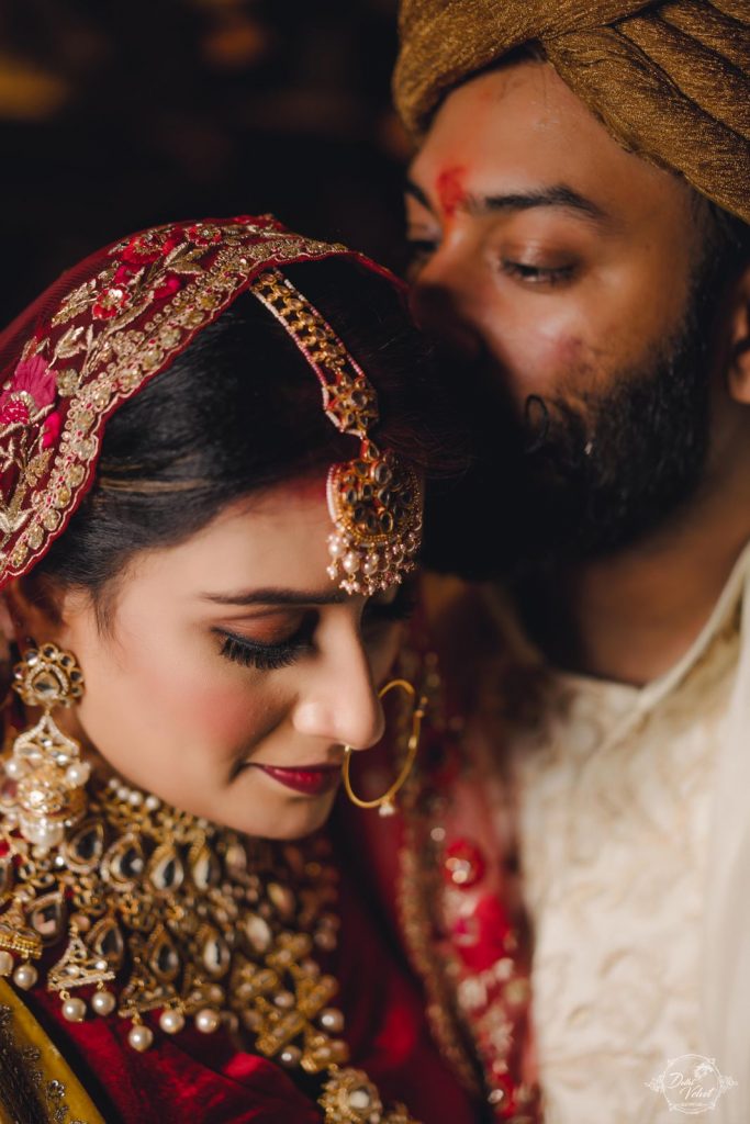 Romantic Couple Portrait of Nikita & Punnet in their Red & Gold Coordinating Wedding outfits for their beach wedding i Pattaya Thailand