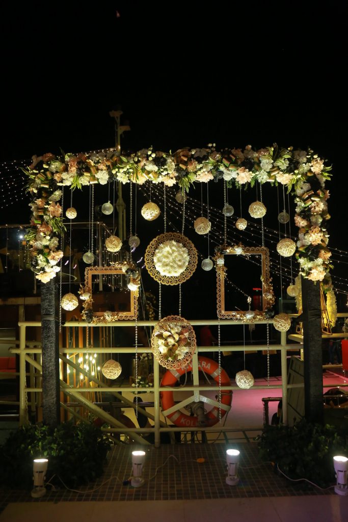 white flowers and golden decoration for sangeet ceremony on a barge