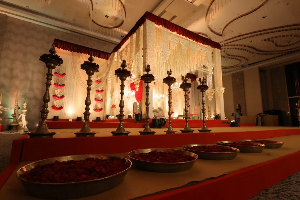 indian wedding mandap with roses and golden accessories