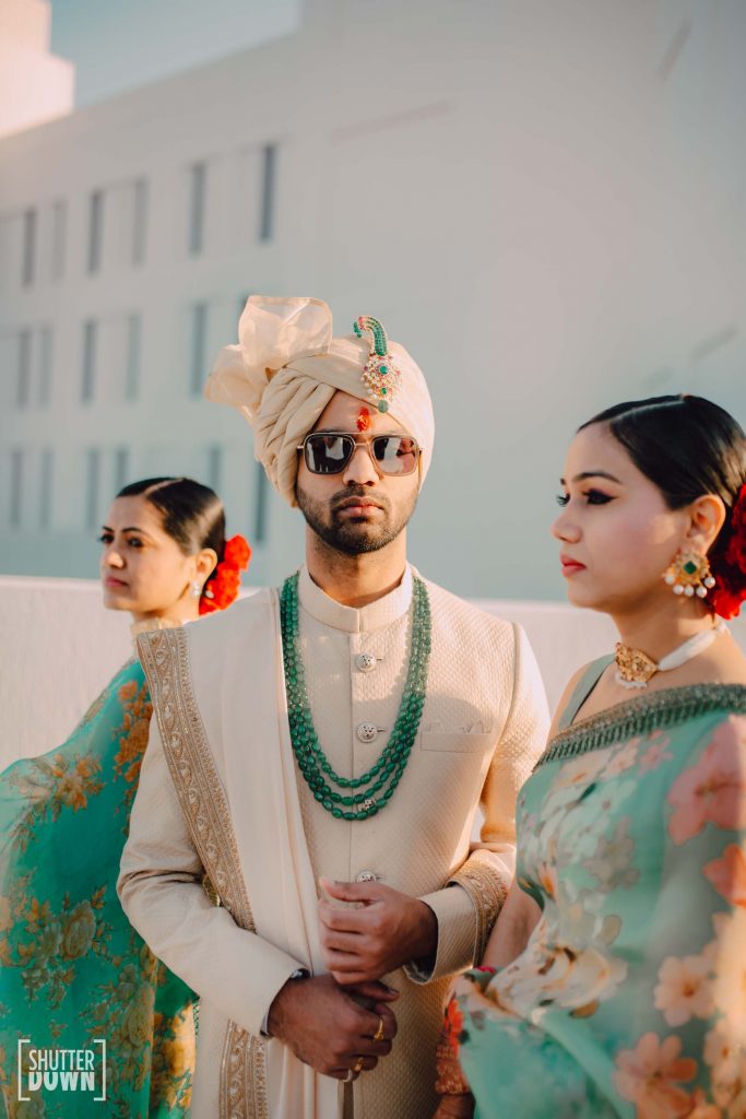 groom sabyasachi sherwani with men green wedding turban sarpeech and beaded necklace 