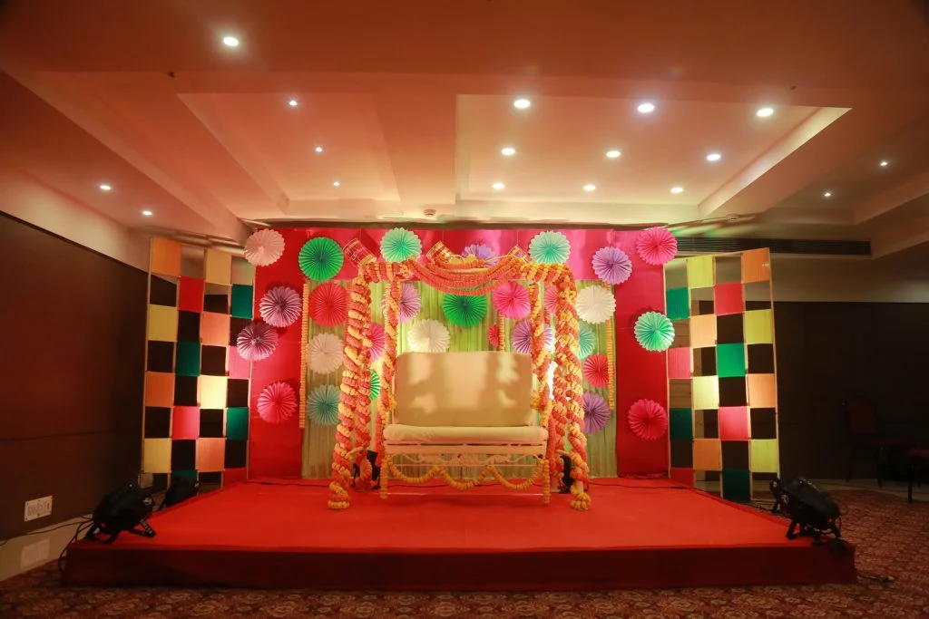 bengali marwari mehendi venue with marigold flower chair and paper decorations