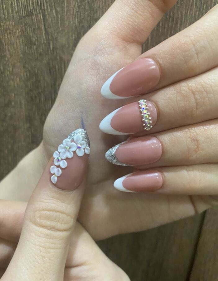 white floral bridal nail art on nude pink nails with glitter french manicure