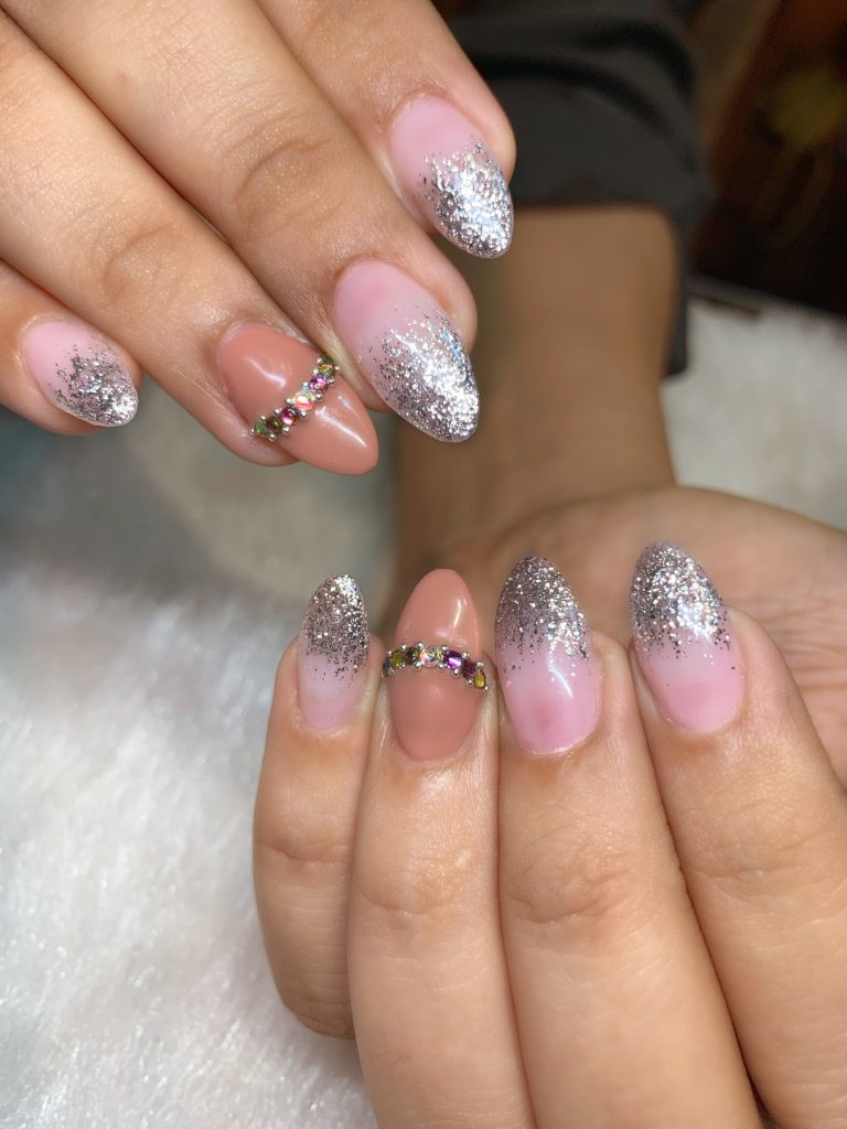 pink nail paint with silver glitter tips and jewels