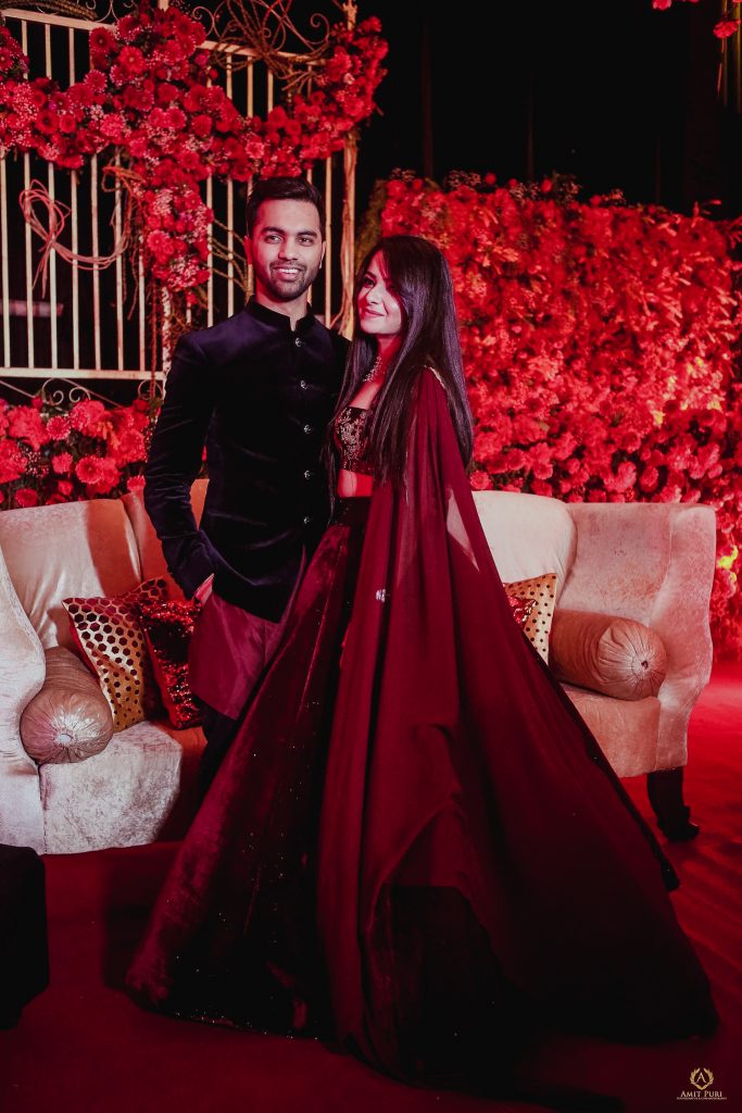 Couple pre wedding reception photoshoot with groom in kurta by Rohit Gandhi and Rahul Khanna and bride in red Manish Malhotra outfit