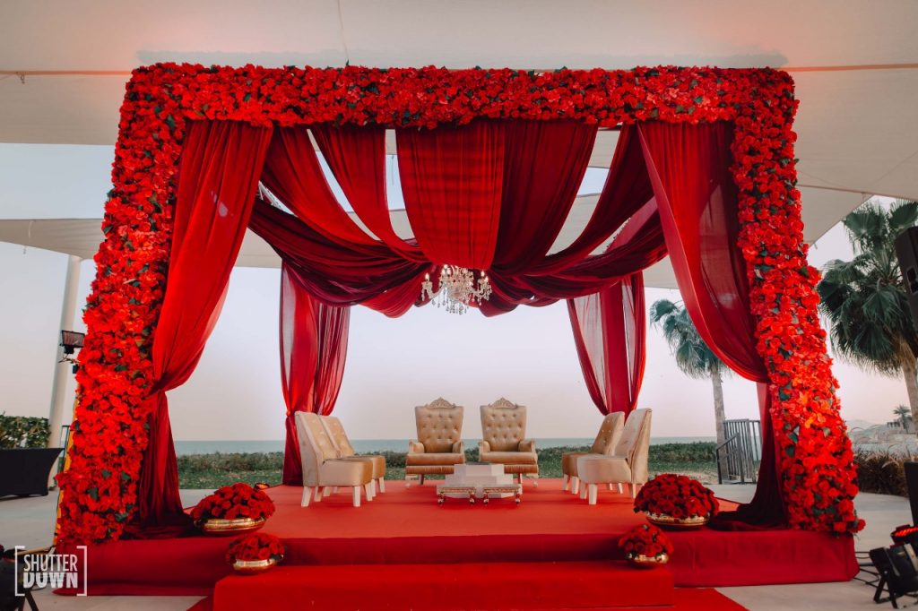 beachside red rose themed floral mandap for beach wedding in dubai