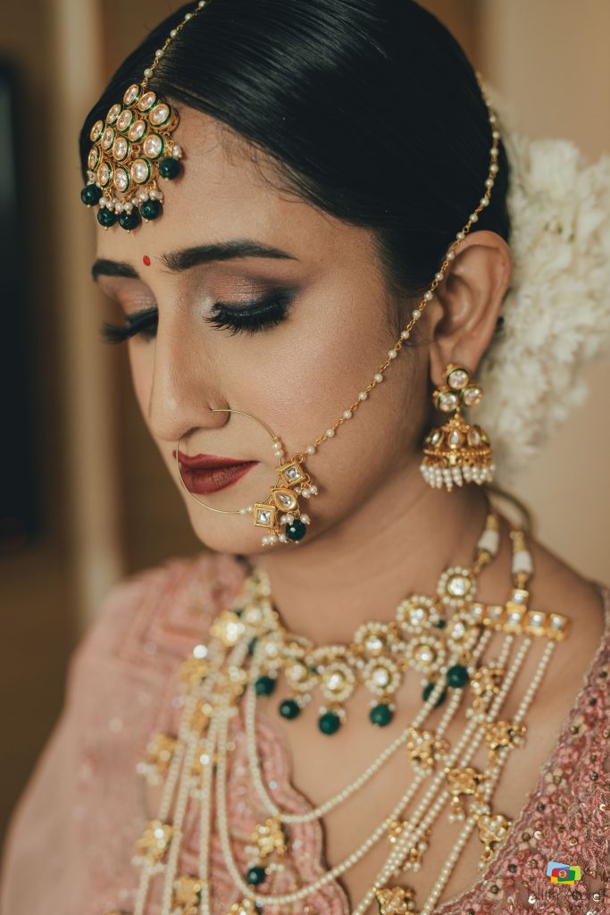 bridal simple copper nude eye makeup look and golden green maang tikka