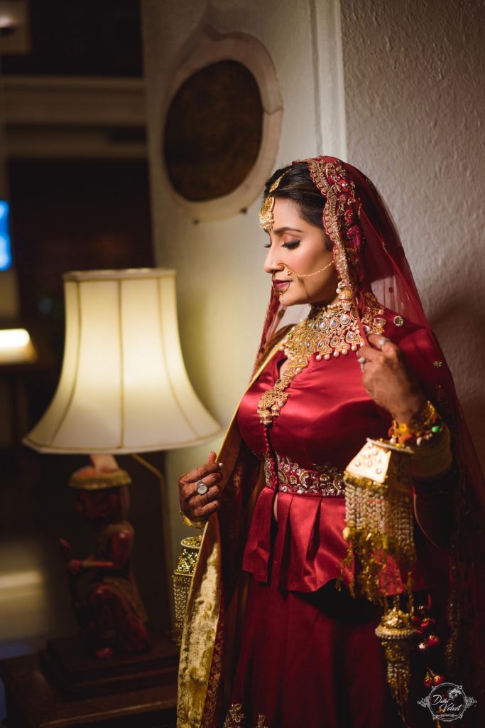 Bride Nikita in a Satin Maroon Designer Wedding Lehenga for her beach wedding in Pattaya