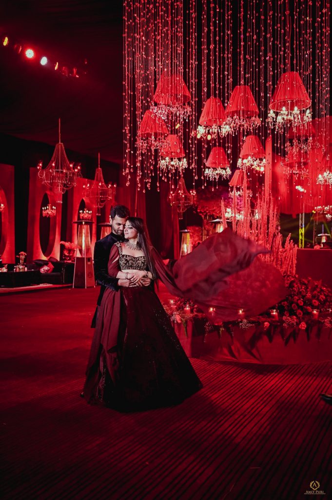 red themed wedding reception photoshoot in velvet red Manish Malhotra designer dress 