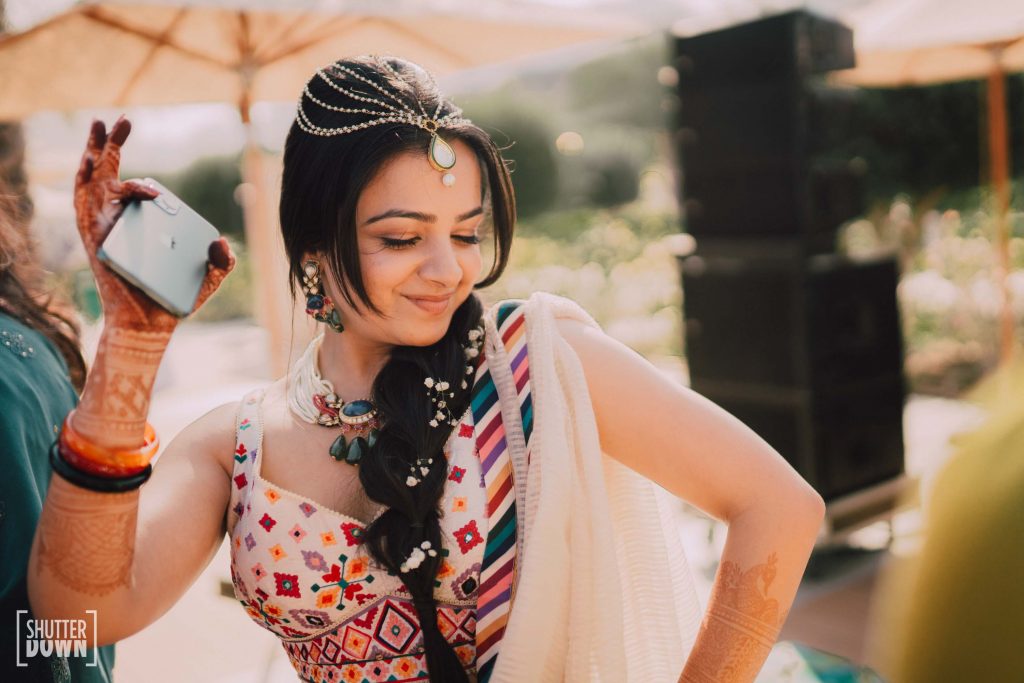 white embroidered lehenga by Tarun Tahiliani and jewelled head chain by Maya Sanghvi