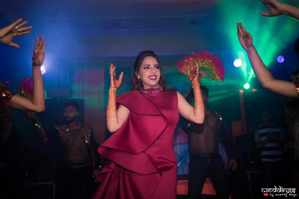 Shalini enjoying her cocktail night in her ruffled maroon dress before her Dusit Thani Hua Hin Wedding