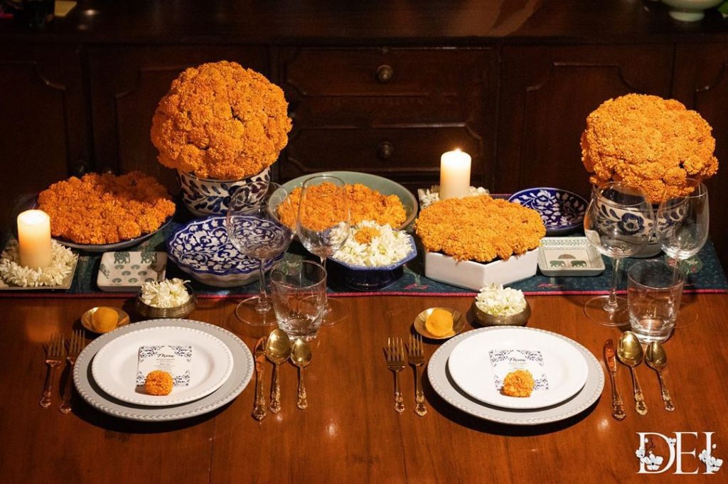 marigold bunches in white porcelain pots for table wear decoration