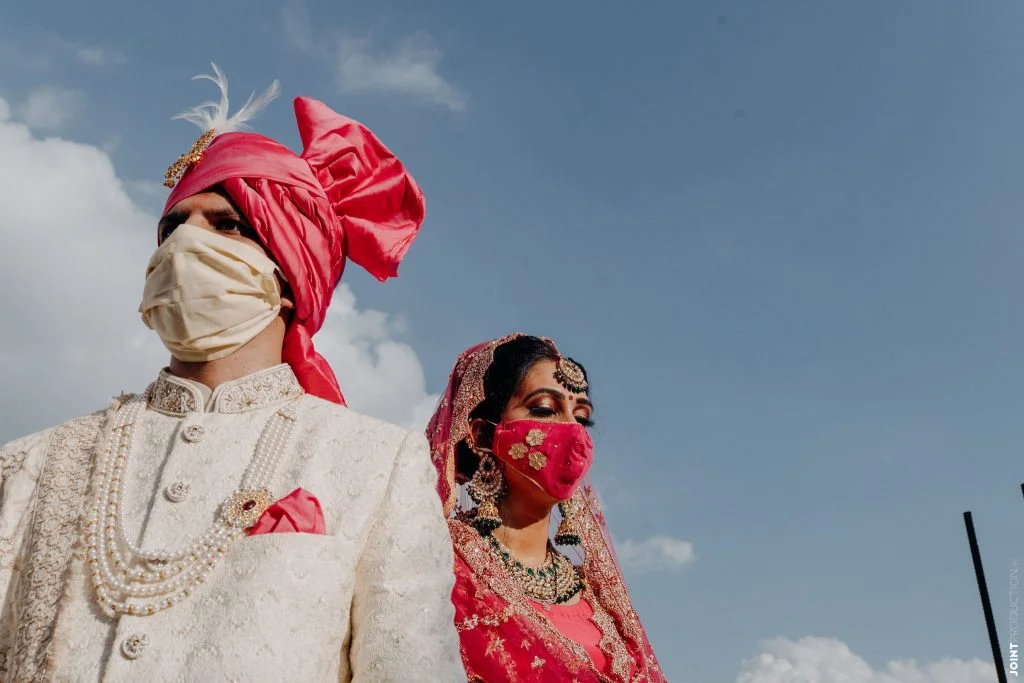 bright pink applique work mask and solid beige bridal face masks for intimate wedding couple