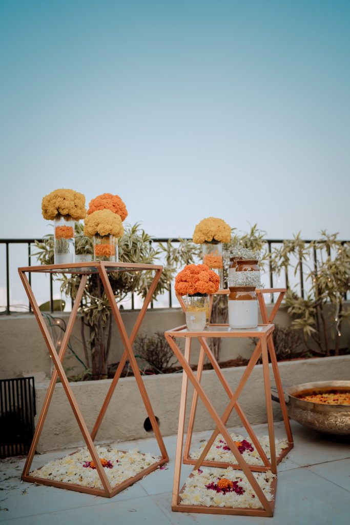 mason jar full of marigolds on a wooden stand