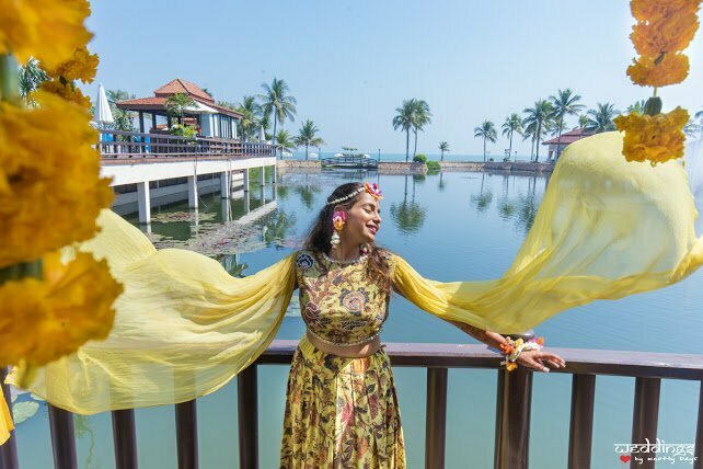 Shalini posing in her designer yellow piece at her Haldi ceremony at Hua Hin, Thailand