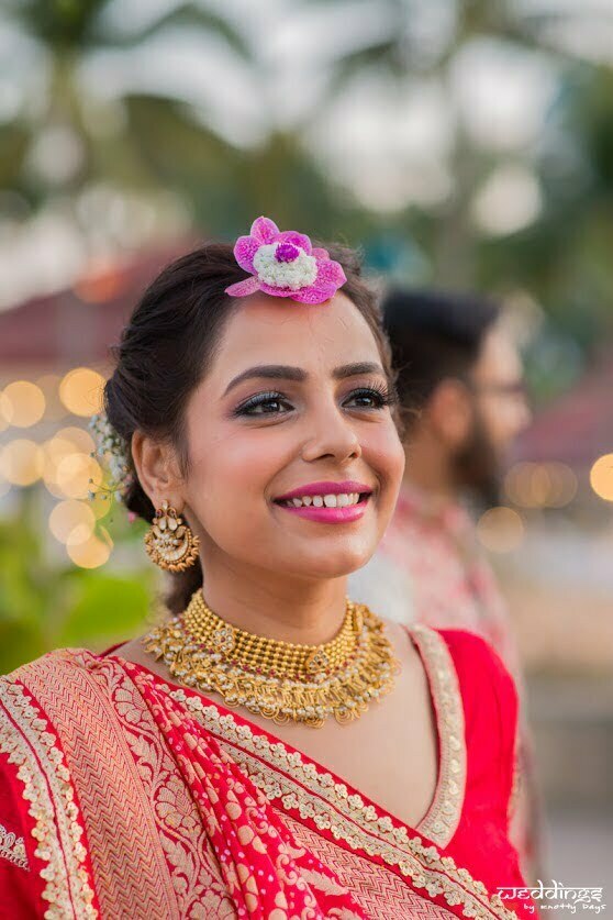 Glowing bride Shalini in her red designer lehenga and beautiful jewellery for her Mehendi Function at Dusit Thani Hua Hin in Thailand