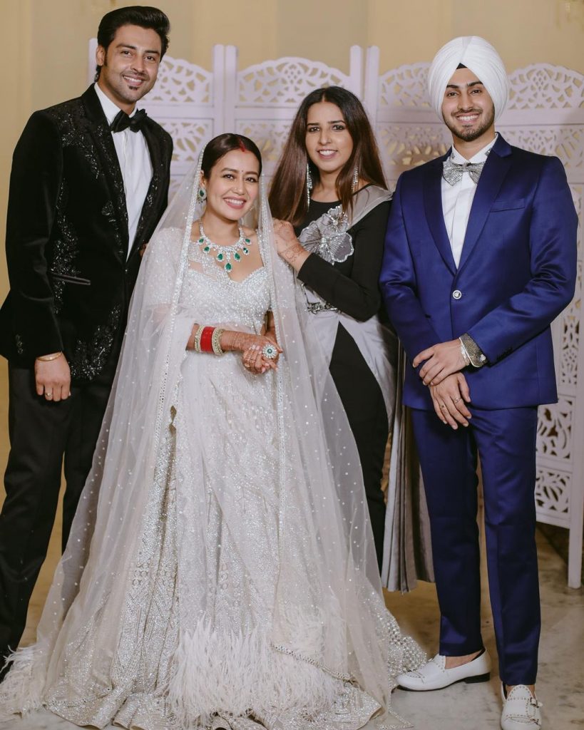 Neha Kakkar and Rohanpreet Singh posing with their guests in their wedding reception