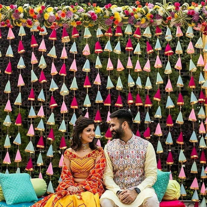 outdoor intimate wedding cloth tassel backdrop with couple posing