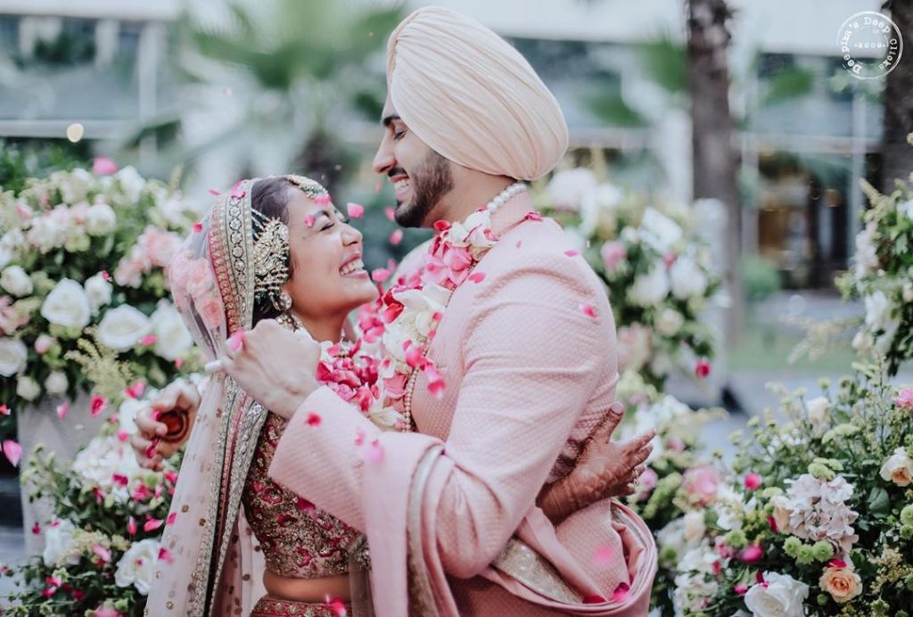 Cute celebrity couple neha kakkar rohanpreet hugging during jaimala ceremony